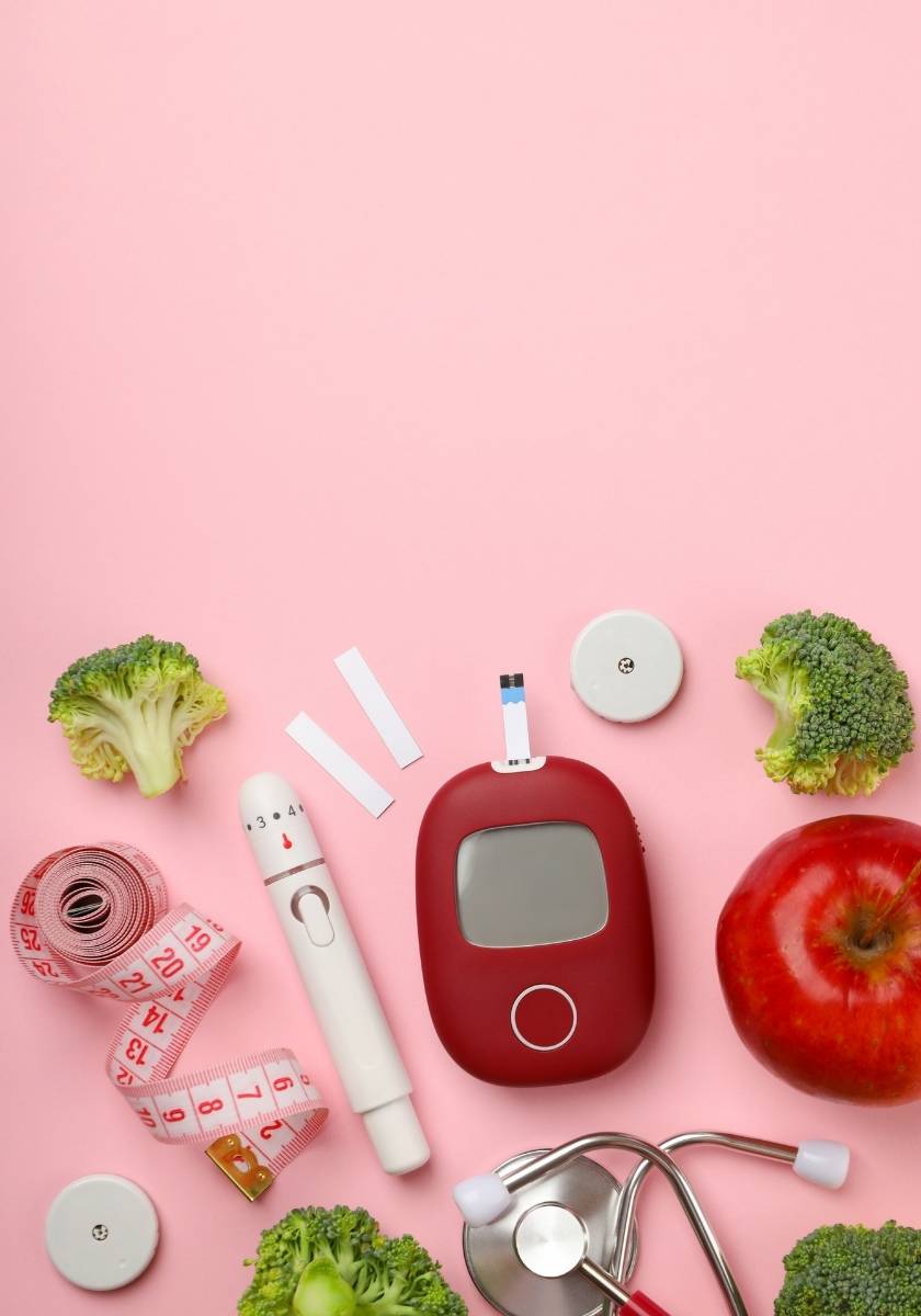 Diabetes testing supplies placed beside fresh vegetables